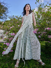 a woman in floral sleeveless dress